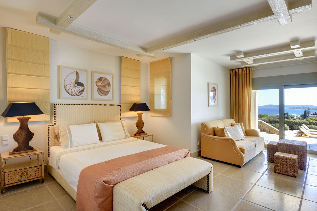 Bedroom opening to the pool terrace and the sea